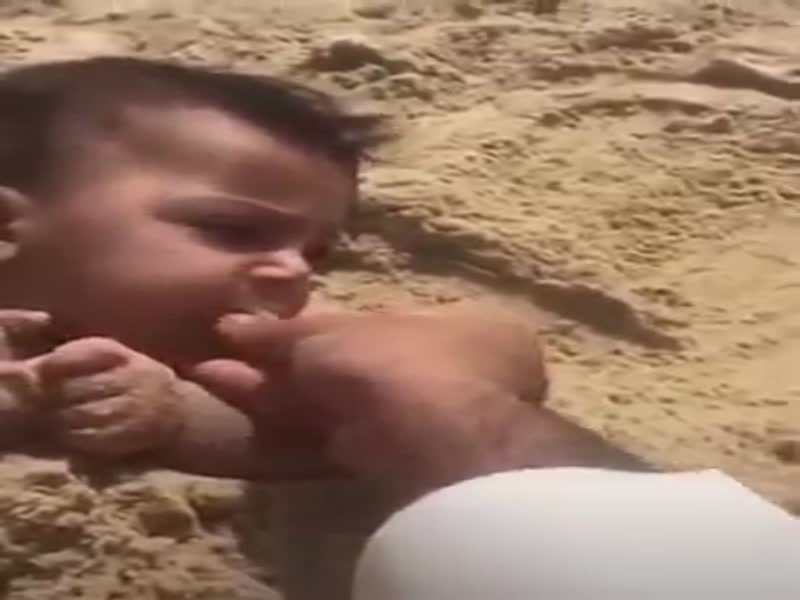 شاهد بالفيديو: أب سعودي يدفن ابنه ويطعمه الرمال!